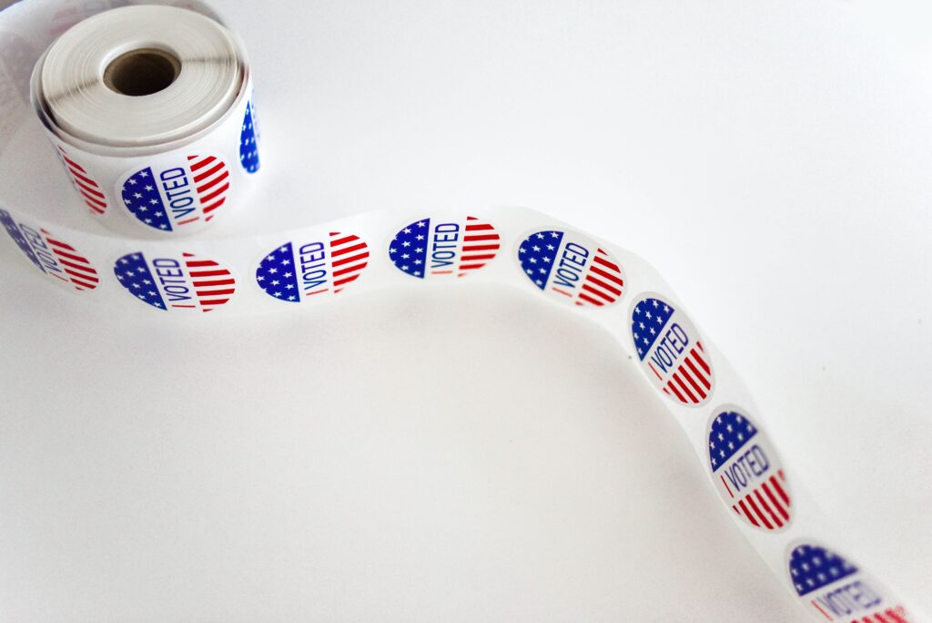 A roll of I Voted stickers with the US stars and bars