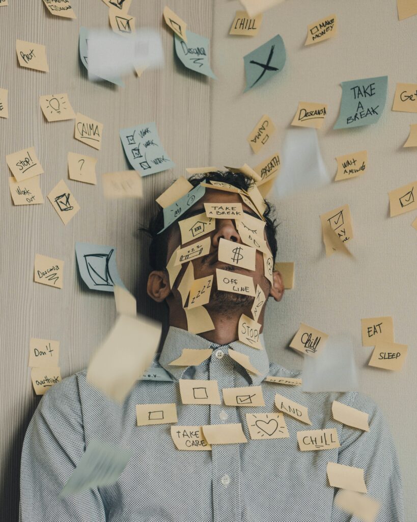 Man on a room corner covered in sticky notes