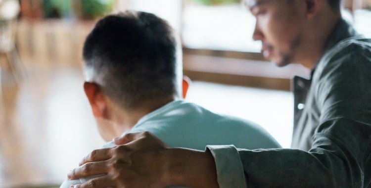 rear-view-of-son-and-elderly-father-sitting-together-at-home-son-for-picture-