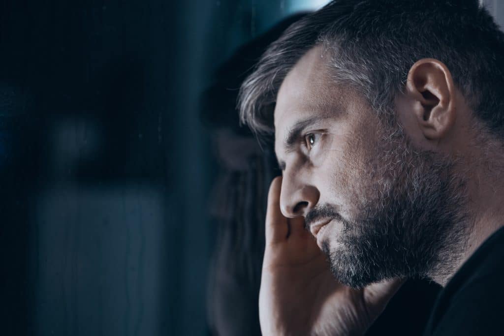 Man struggling with Xanax abuse looking blankly
