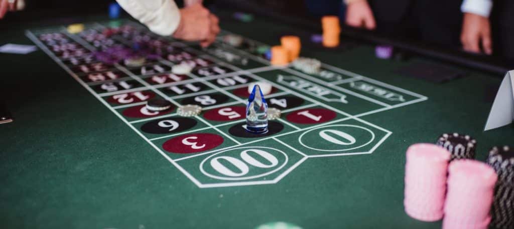 Men in business attire playing roulette at a casino